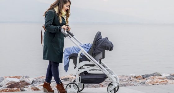 Mother pushing her baby in a pram
