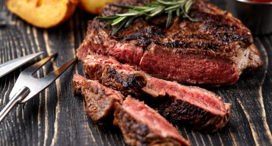 Rare beef steak sliced on wooden plate from Churrasco Steak House