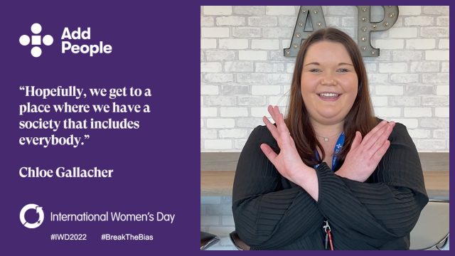 International Women's Day Questions - woman stood, smiling crossing arms in an X to show support for #BreakTheBias
