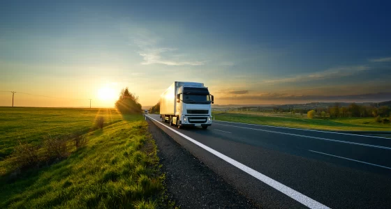 Europa Truck Parts - truck on highway with sunrise behind