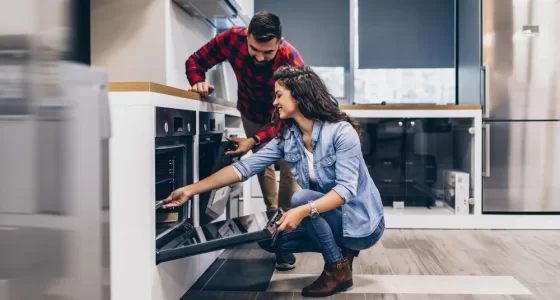 All Your Appliances - couple inspecting oven in appliance store
