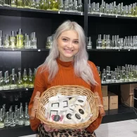 Black Point Perfumes Owner, Karolina Stonkute, holding basket of products in store
